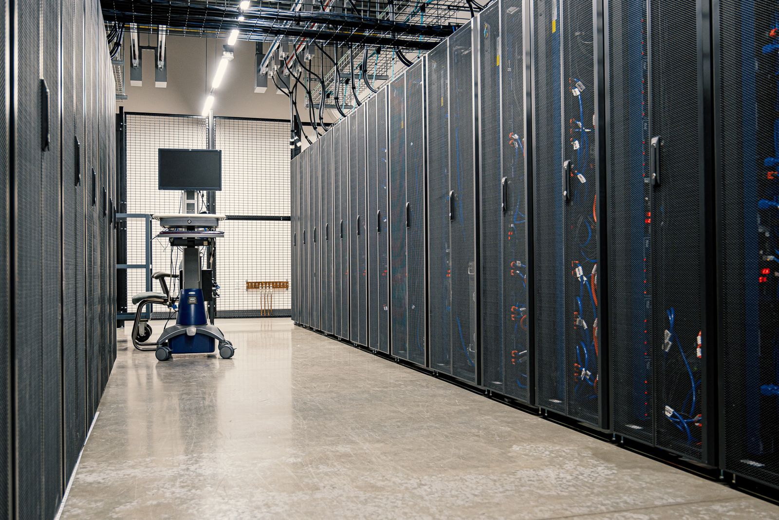 Aisle of server racks in a data center